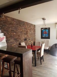 a dining room with a brick wall and a table and chairs at WindRose 6 in Madrid