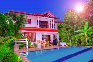 a house with a swimming pool in front of a house at Villu Villa in Anuradhapura