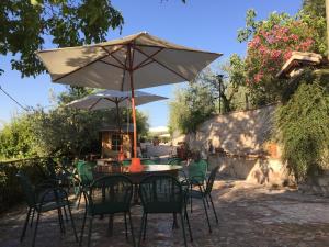 a table with chairs and an umbrella on a patio at Il renaiolo in Spello