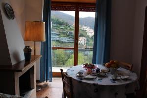 a table with a bowl of fruit on it in front of a window at Tramonti Green in Tramonti