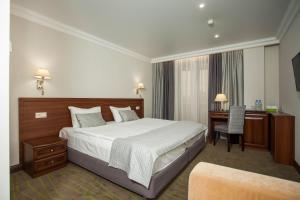 En eller flere senge i et værelse på Platan Yuzhniy Hotel