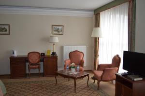 ジュコーフスキーにあるHotel Evropaのリビングルーム(テレビ、椅子付)が備わる客室です。