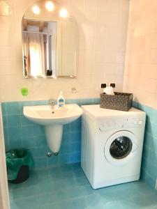 bagno con lavatrice e lavandino di Apartments Tony in Bardolino a Bardolino