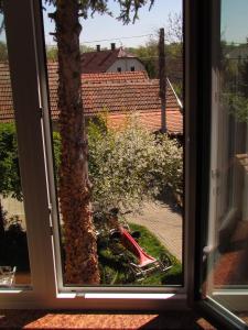 a window with a view of a motorcycle outside at Torkolat Panzió in Tokaj