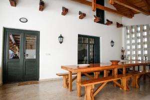 a dining room with a wooden table in a room at Erzsébet Pince in Tokaj