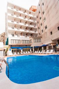 a large swimming pool in front of a hotel at Hotel Cassandra in El Arenal