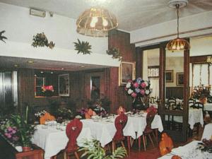 a group of people sitting at a table in a restaurant at Albergo ristorante Gnocchi in Cortenova