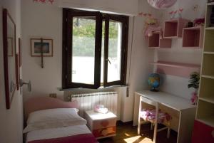 a small bedroom with a bed and a window at Casa Anna a Pietrasanta in Toscana con piscina in Pietrasanta +56 photos