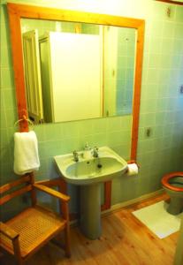 a bathroom with a sink and a mirror and a toilet at Denmore Guest House in Aberdeen