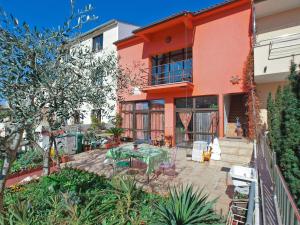 an orange building with a patio with a table at Apartments Kada 1571 in Pula
