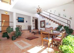 a living room with a table and stairs at Apartments Kada 1571 in Pula