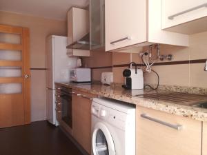 a kitchen with a washer and dryer at Atico Duplex con parking propio in Peniscola