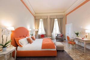 a bedroom with an orange bed and a desk at Luxury Bed and Breakfast Cerretani Palace in Florence