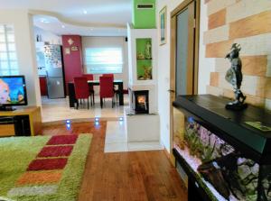 a living room with a fish tank and a dining room at Apartments Europa in Starigrad