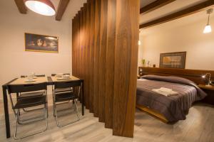 una camera con letto e tavolo con sedie di NOVA DOMUS S. PAOLO a Sorrento