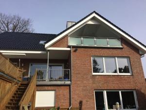 a red brick house with a black roof at Haus Antje in Scharbeutz