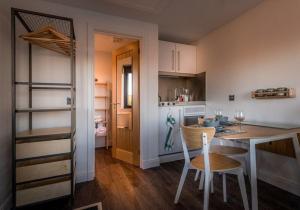 a kitchen with a table and two chairs and a counter at Elfin Cottage in Portree