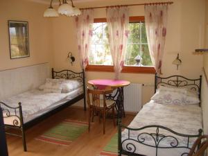 A bed or beds in a room at Bundi Vendégház