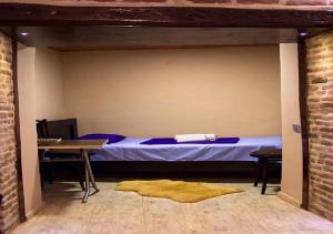 a bedroom with a bed and a table with a table at Feel Old Tbilisi in Tbilisi City