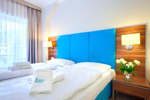 Posteľ alebo postele v izbe v ubytovaní Apartamenty AmberHome