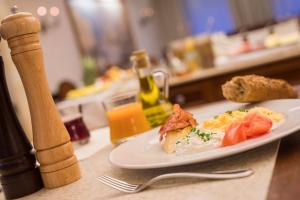 a plate of food sitting on a table with food at Retro Riverside Wellness Resort in Karlovy Vary