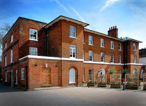 a large red brick building with white windows at Montague House in Wokingham