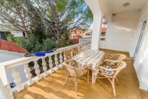 a patio with a table and chairs on a balcony at Apartments Ivica - with parking in Nin