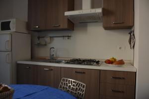 a kitchen with a sink and a stove top oven at App. a 30mt dal mare in Pietra Ligure