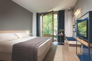 Rúm í herbergi á Parc Hotel Billia