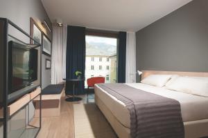 Rúm í herbergi á Parc Hotel Billia