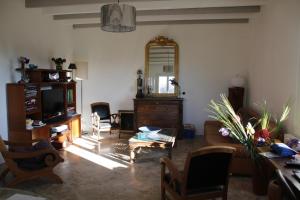 a living room with a couch and a mirror at ancienne ferme rénovée in Upie