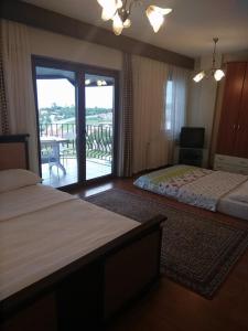 a hotel room with two beds and a balcony at Dikcati Pension in Şile