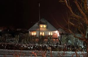 a house at night with its lights on at Haus Daheim in Utersum