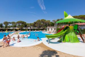 a group of people in a pool at a water park at Vela Blu Camping Village in Cavallino-Treporti