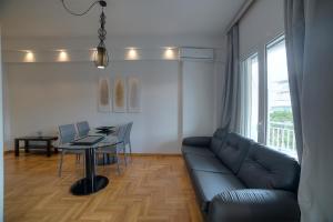 a living room with a couch and a table at Apartment in Glyfada Center in Athens