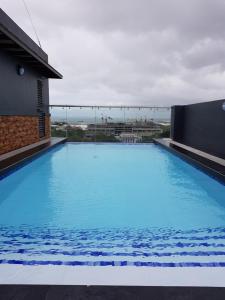 a large blue swimming pool on top of a building at Skymagz 314 at Cityscape Residences in Bacolod