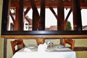 a table with a white table cloth and a window at Le Clos Margot in Vertus