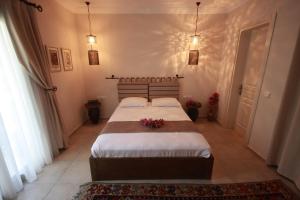 a bedroom with a large bed with flowers on it at Dardanos Hotel in Patara