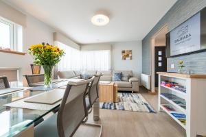 a kitchen and living room with a table and chairs at Dalriada Lodges Downie in Stonehaven