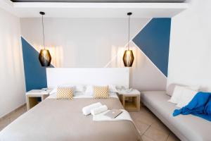 a bedroom with two beds and two tables at Hotel Rivage in Sorrento