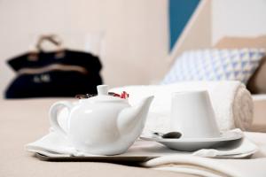 a table with a tea pot and a cup on it at Hotel Rivage in Sorrento
