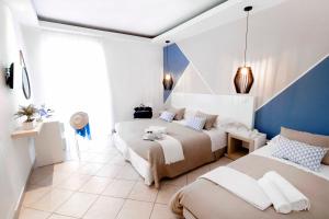a bedroom with two beds and a blue and white wall at Hotel Rivage in Sorrento +37 photos