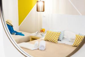 a hotel room with two beds and a mirror at Hotel Rivage in Sorrento