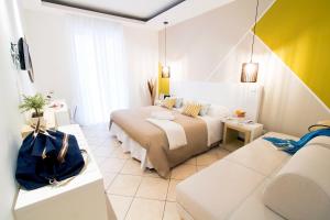 a hotel room with a bed and a couch at Hotel Rivage in Sorrento