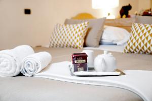 a hotel room with towels and a tray with a candle at Hotel Rivage in Sorrento