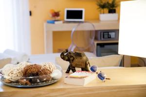 a table with a plate of noodles and a figurine at Hotel Rivage in Sorrento