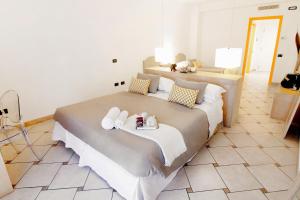 a bedroom with a large bed with towels on it at Hotel Rivage in Sorrento