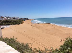 a view of a beach with people walking on it at Casa Alzira By ALzira in Albufeira