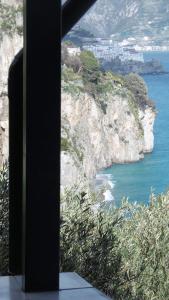 a room with a view of the ocean and mountains at Blue Lagoon in Amalfi