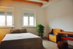 a bedroom with a bed and two windows at Villa Berlin-Seehof in Teltow